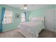 Bedroom with white walls, ceiling fan, two windows and a cozy bed with white linens at 317 Flatrock Ln, Holly Springs, NC 27540