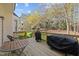 Outdoor deck with table, chairs, and grilling area, perfect for entertaining in the private backyard at 317 Flatrock Ln, Holly Springs, NC 27540