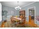 Elegant dining room featuring a wooden table, traditional decor, and hardwood floors at 317 Flatrock Ln, Holly Springs, NC 27540