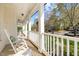 Relaxing front porch with rocking chairs, offering a pleasant view of the neighborhood at 317 Flatrock Ln, Holly Springs, NC 27540