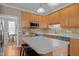A kitchen featuring oak cabinets, a central island, and stainless steel appliances at 317 Flatrock Ln, Holly Springs, NC 27540