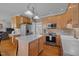 Open kitchen featuring oak cabinets, stainless steel appliances, and a central island at 317 Flatrock Ln, Holly Springs, NC 27540