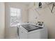 Bright laundry room with white washer and dryer appliances at 317 Flatrock Ln, Holly Springs, NC 27540
