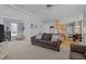 Open-concept living room with seamless transition to the kitchen and seating area at 317 Flatrock Ln, Holly Springs, NC 27540
