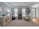 Well-lit living room with two windows, tray ceilings, and neutral color scheme, offering a welcoming space at 317 Flatrock Ln, Holly Springs, NC 27540