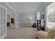 Stylish living room with French doors, neutral paint, carpet floors and comfortable seating at 317 Flatrock Ln, Holly Springs, NC 27540