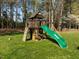 Backyard wooden playset structure with slide and climbing wall at 317 Flatrock Ln, Holly Springs, NC 27540