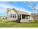 Exterior view of a home featuring a screened-in porch and well-maintained lawn at 3213 Kirby St, Durham, NC 27713