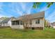 Lovely backyard featuring a home with a sunroom addition, set in a serene environment with a tree adding natural beauty at 3213 Kirby St, Durham, NC 27713