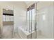 Bright bathroom featuring a tiled shower, soaking tub, and an open doorway to the bedroom at 3213 Kirby St, Durham, NC 27713