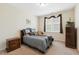 Cozy bedroom showcasing a comfortable bed, window with curtains, and wood furniture at 3213 Kirby St, Durham, NC 27713