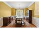 Elegant dining room with a large table set, classic chandelier, and beautiful hardwood floors at 3213 Kirby St, Durham, NC 27713