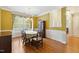 Bright dining room with hardwood floors and large windows, perfect for Gathering gatherings or celebrations at 3213 Kirby St, Durham, NC 27713