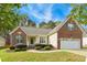 Charming brick and siding home with manicured landscaping, two-car garage and well-maintained lawn at 3213 Kirby St, Durham, NC 27713