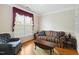 Cozy living room with hardwood floors, large windows, and comfortable seating with neutral walls at 3213 Kirby St, Durham, NC 27713