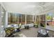 Bright sunroom featuring wicker furniture, a ceiling fan, and natural light at 3213 Kirby St, Durham, NC 27713