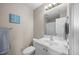 Well-lit bathroom with a vanity, toilet, framed mirror, and essential fixtures at 3471 Forestdale Drive # 3C, Burlington, NC 27215