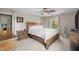 Well-lit bedroom with a large bed, ceiling fan, hardwood furnishings, and a comfortable ambiance at 3471 Forestdale Drive # 3C, Burlington, NC 27215