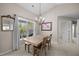 Cozy dining area with a wooden table, four chairs, chandelier, and lots of natural light at 3471 Forestdale Drive # 3C, Burlington, NC 27215