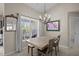 Cozy dining area with a wooden table, four chairs, chandelier, and lots of natural light at 3471 Forestdale Drive # 3C, Burlington, NC 27215
