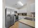 Well-lit kitchen featuring stainless steel appliances, white cabinets, and laminate countertops at 3471 Forestdale Drive # 3C, Burlington, NC 27215