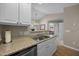 The kitchen includes stainless steel appliances, laminate countertops, and views into the dining area at 3471 Forestdale Drive # 3C, Burlington, NC 27215