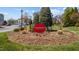 Community entrance sign amidst landscaped foliage at Oak Grove Crossing at 3471 Forestdale Drive # 3C, Burlington, NC 27215
