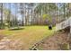 Spacious backyard featuring a trampoline, lush trees, and ample space for outdoor activities and play at 384 Rocky Run Ln, Lillington, NC 27546