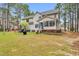 The backyard showcases a well-maintained lawn and an inviting screened porch, ideal for relaxation and gatherings at 384 Rocky Run Ln, Lillington, NC 27546