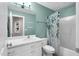 A bathroom features a decorative mirror, white cabinets, and a shower with a floral curtain at 384 Rocky Run Ln, Lillington, NC 27546