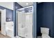 A modern bathroom with a walk-in glass shower enclosure, toilet, and large white soaking tub is inviting at 384 Rocky Run Ln, Lillington, NC 27546