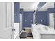 Bathroom featuring double sinks, a soaking tub, and updated lighting at 384 Rocky Run Ln, Lillington, NC 27546