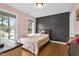 A charming bedroom has hardwood floors and two windows, offering plenty of natural light and a peaceful atmosphere at 384 Rocky Run Ln, Lillington, NC 27546