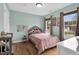 This sun-filled bedroom has a full-size bed, hardwood floors, and two windows with great light at 384 Rocky Run Ln, Lillington, NC 27546