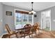 Bright breakfast nook featuring a wooden table and large windows overlooking the backyard at 384 Rocky Run Ln, Lillington, NC 27546