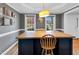 Dining room features a large kitchen island with bar stool seating and updated lighting at 384 Rocky Run Ln, Lillington, NC 27546