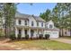 Two-story home with a two-car garage, green lawn and a covered front porch at 384 Rocky Run Ln, Lillington, NC 27546