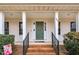 Inviting front porch features brick steps, black railings, and a freshly painted front door at 384 Rocky Run Ln, Lillington, NC 27546