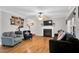 Comfortable living room features hardwood floors, fireplace, and a ceiling fan at 384 Rocky Run Ln, Lillington, NC 27546