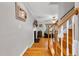 View from stairs to living room with fireplace and hardwood floors at 384 Rocky Run Ln, Lillington, NC 27546