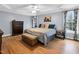 Spacious main bedroom features hardwood floors, ceiling fan, and a large window at 384 Rocky Run Ln, Lillington, NC 27546