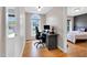 Home office featuring hardwood floors, a large window, and a black desk at 384 Rocky Run Ln, Lillington, NC 27546
