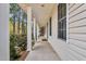 Spacious covered porch with classic columns and ample room for outdoor seating at 384 Rocky Run Ln, Lillington, NC 27546