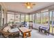 This sunroom is filled with natural light, features comfortable seating, and a kitchen play area at 384 Rocky Run Ln, Lillington, NC 27546