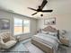 Cozy bedroom with a large window, a ceiling fan, and neutral decor at 39 Calluna Dr, Clayton, NC 27520
