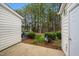 View of the backyard showing mature trees and the side of the house at 4114 Brenmar Ln, Durham, NC 27713