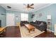 Inviting living room with dark wood floors, a ceiling fan, and a cozy seating arrangement at 4114 Brenmar Ln, Durham, NC 27713