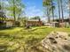 Lush backyard featuring mature trees, a fenced perimeter, and a storage shed at 416 Avery St, Garner, NC 27529