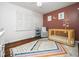 Cozy Bedroom featuring hardwood floors, natural light, and a charming crib, creating a peaceful space at 416 Avery St, Garner, NC 27529
