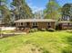 Charming brick home with a well-manicured lawn and inviting front porch, perfect for relaxing outdoors at 416 Avery St, Garner, NC 27529
